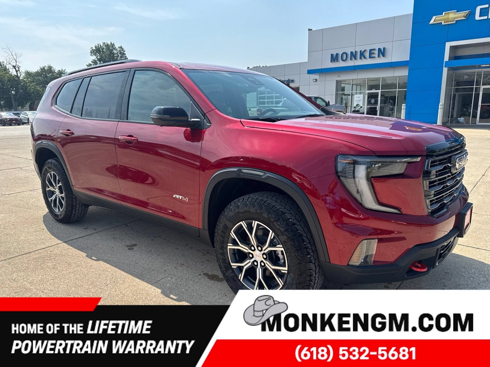 2026 GMC Acadia AT4 in Volcanic Red Tintcoat — front three-quarter view